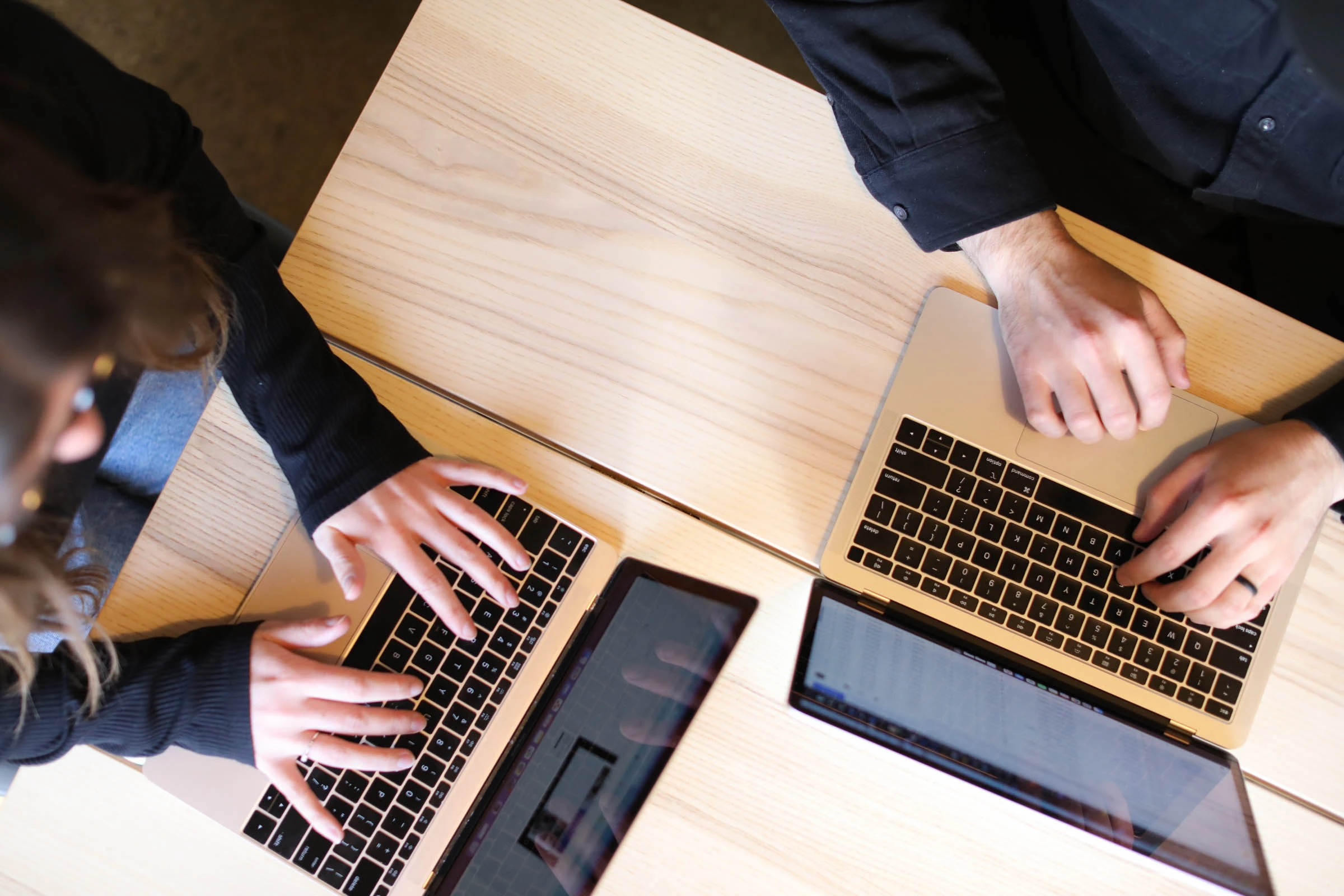 two people at laptops